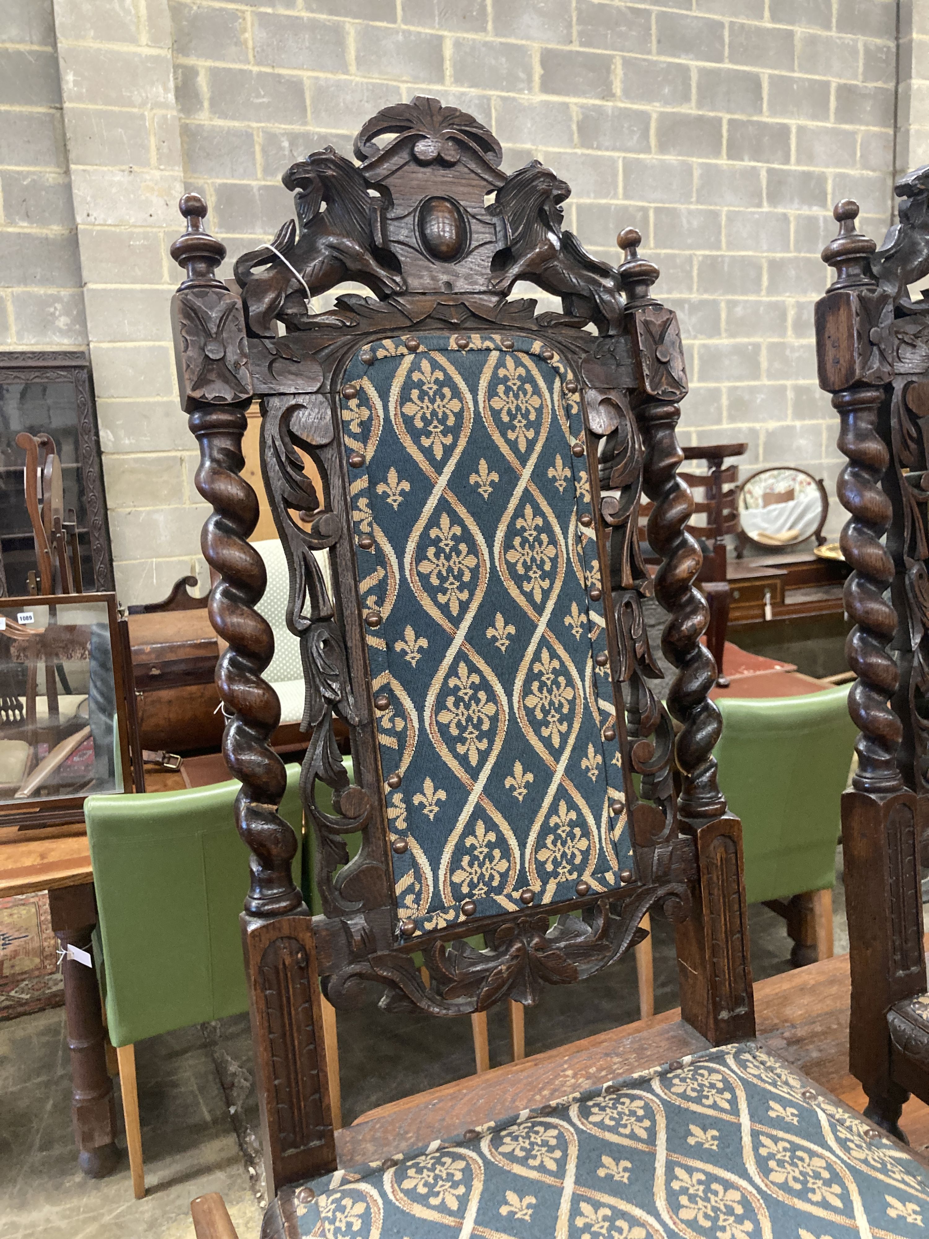 A pair of late 19th century Flemish carved oak panel backed dining chairs